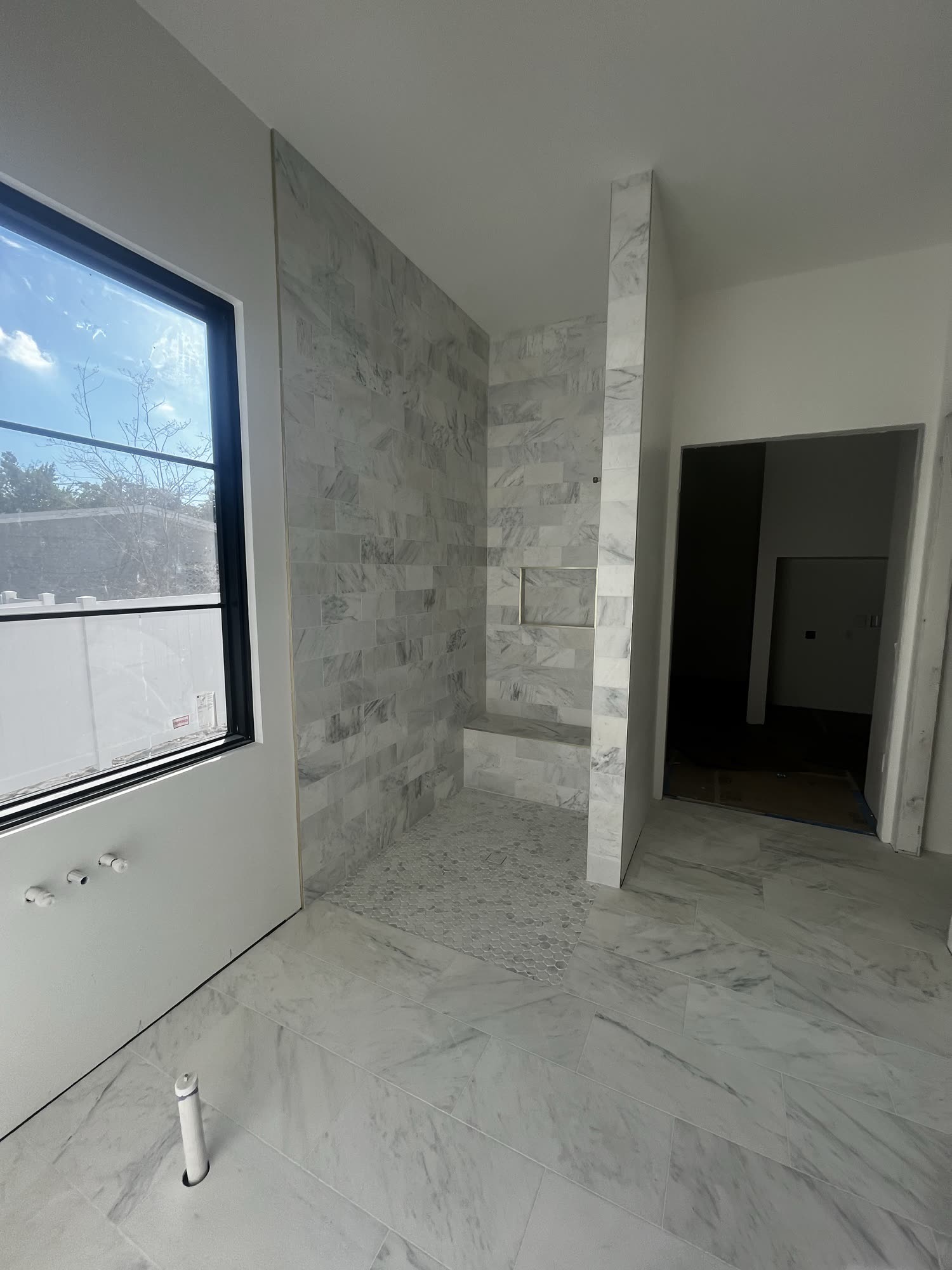 Marble shower tile with natural light in a Winter Park, FL home
