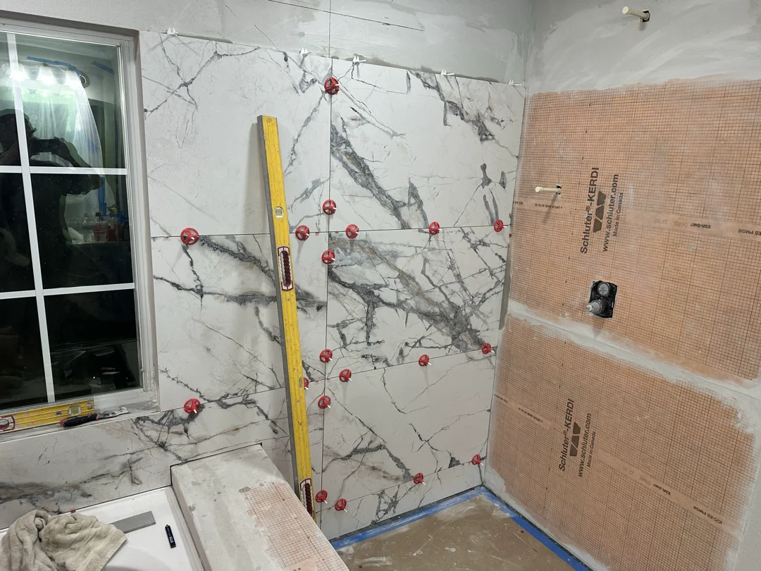 KV Tileworks installing a large-format marble slab wall