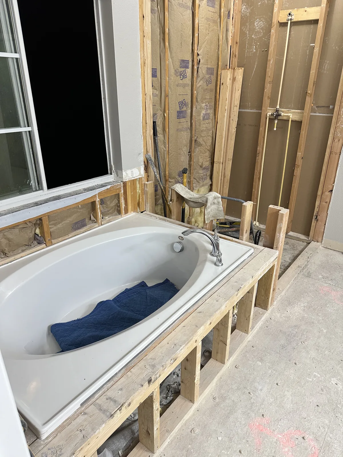 Demolition: the Sanford bathroom gutted to the studs with old tub and exposed framing